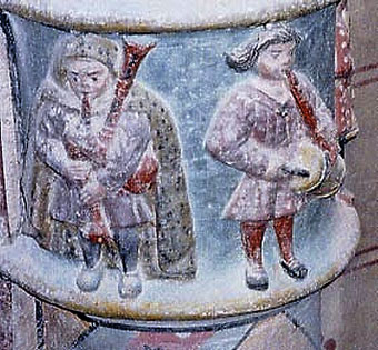 Un tambourinaïre et un bodegaïre entament peut-être une "carole" sur un des chapiteaux polychrome de Villardonnel