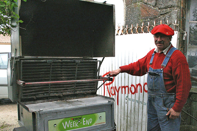 Raymond devant le modèle de barbecue qu’il a imaginé pour les professionnels et qui permet la cuisson de près de 50 magrets… 